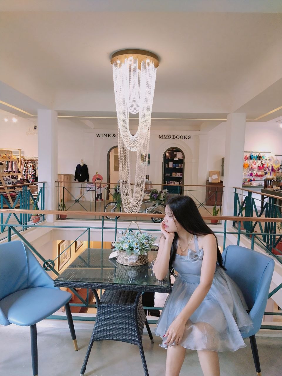 Designer thoughtfully draping ivory fabric in the Amara Htoo atelier
